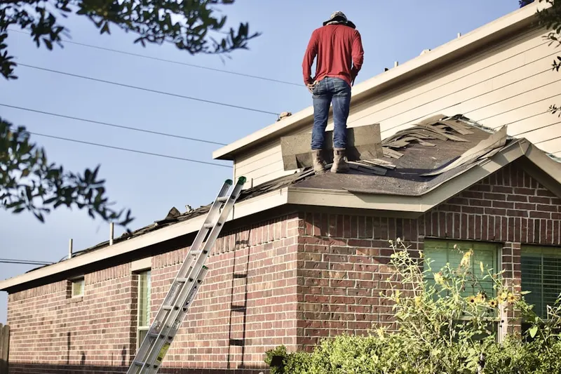 Professional roofer working on a residential roof in Moores Corner